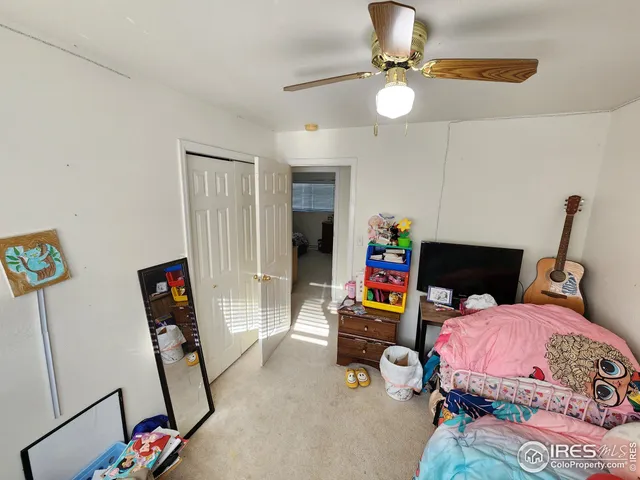 a bedroom with bed and glass door