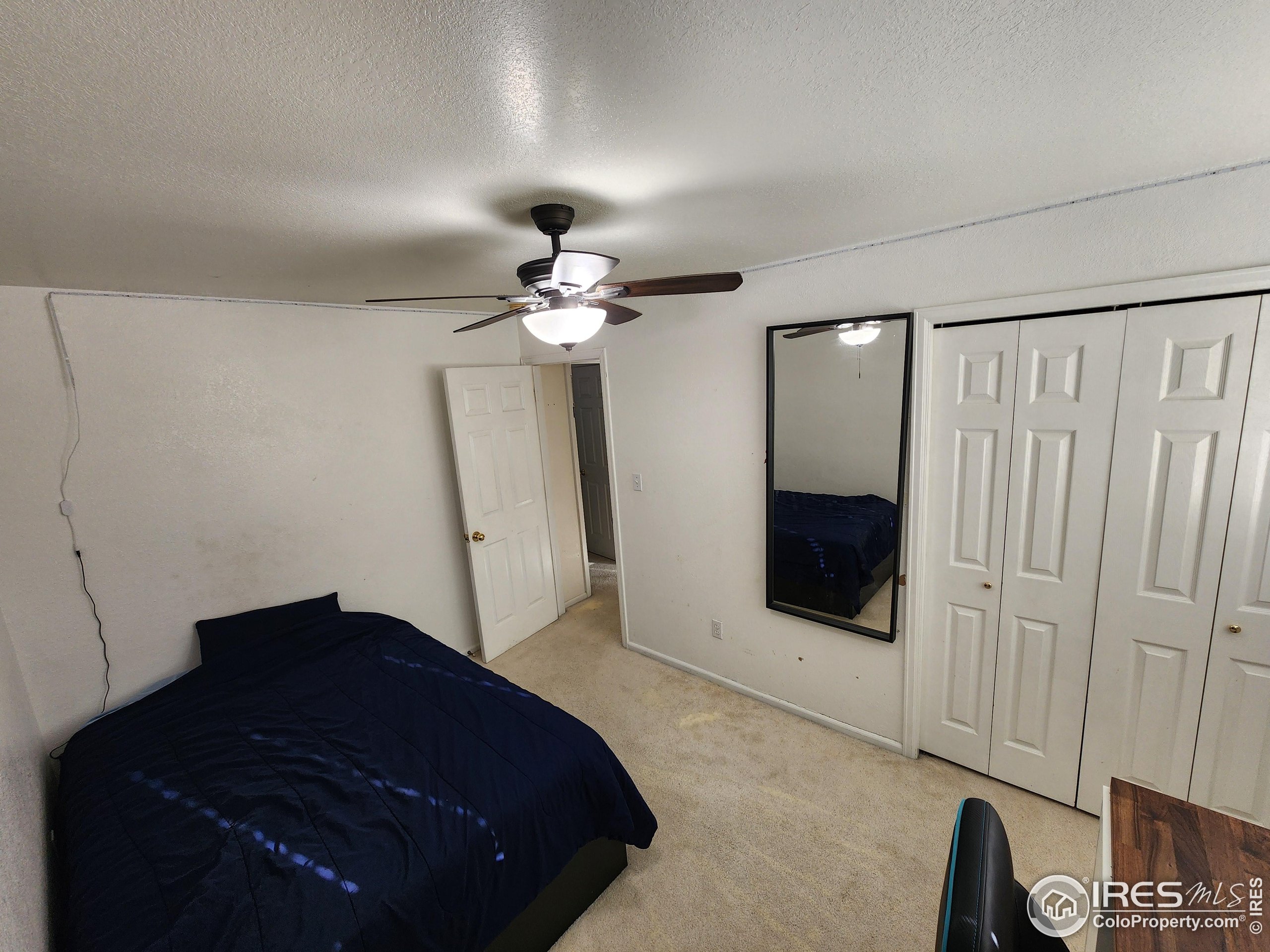 1324 Dawes Street Sterling, CO 80751 - Photo 17 of 39 a bedroom with a bed and a mirror