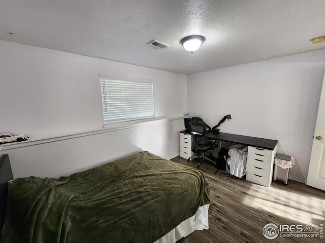 a bedroom with a bed and cabinets