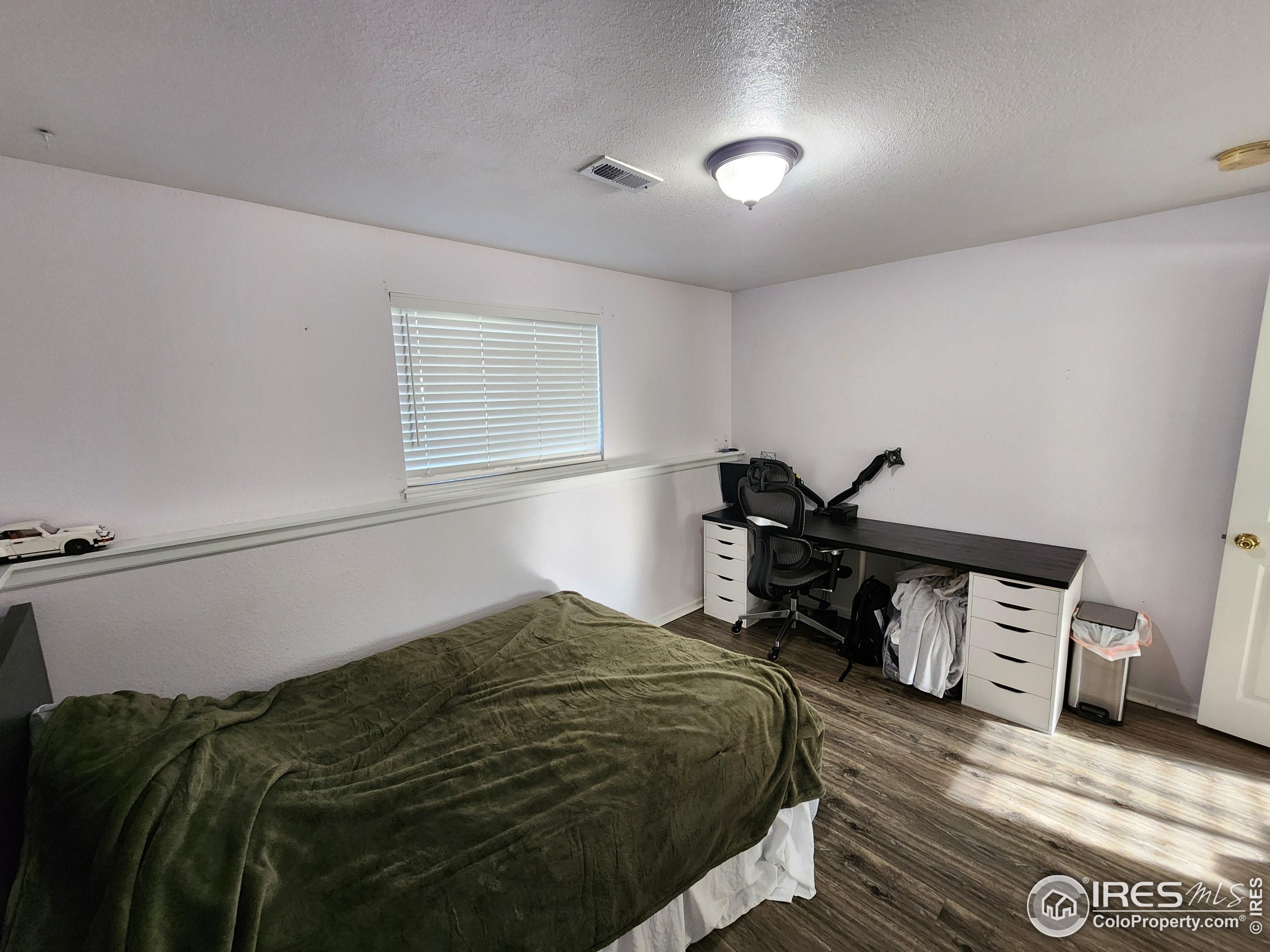 1324 Dawes Street Sterling, CO 80751 - Photo 23 of 39 a bedroom with a bed and a window
