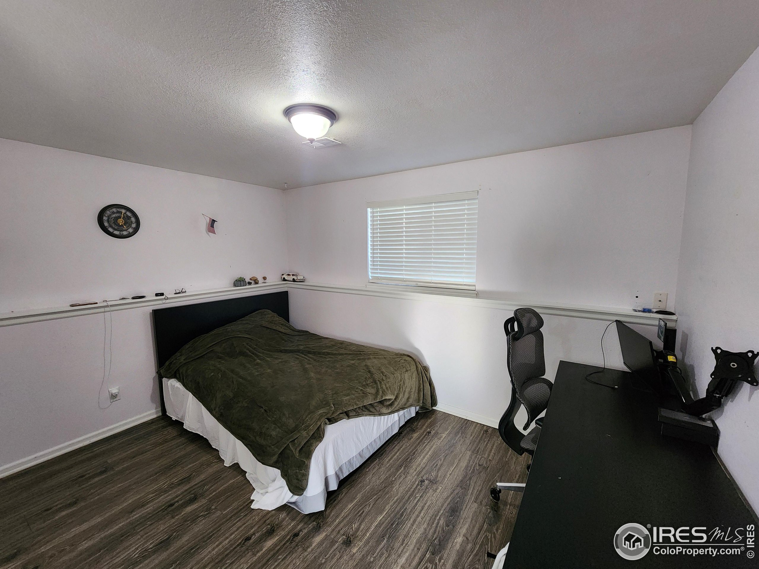 1324 Dawes Street Sterling, CO 80751 - Photo 24 of 39 a bedroom with a bed and cabinets