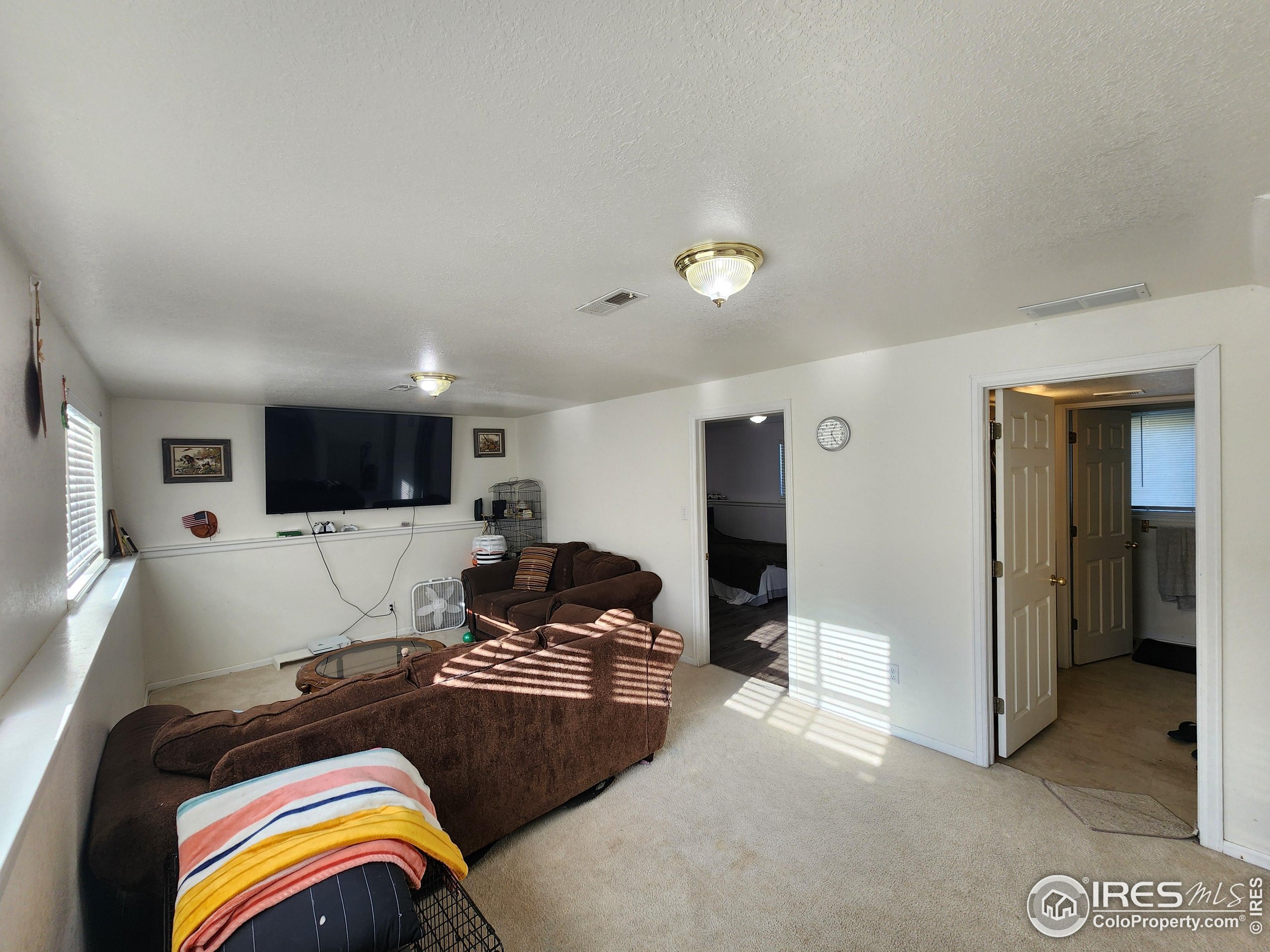 1324 Dawes Street Sterling, CO 80751 - Photo 26 of 39 a living room with furniture and a flat screen tv