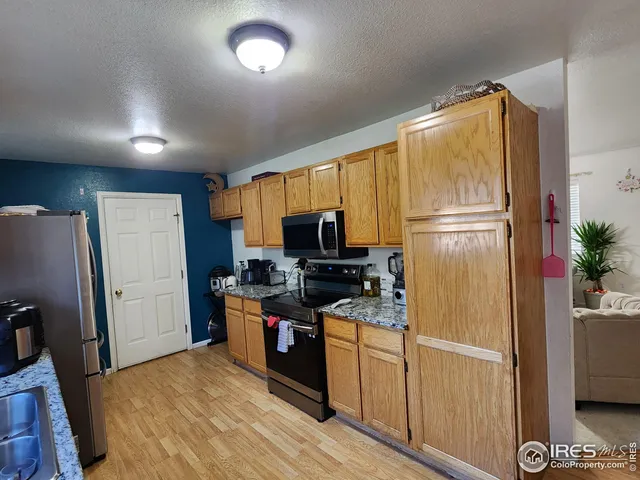 a kitchen with stainless steel appliances a refrigerator stove and microwave