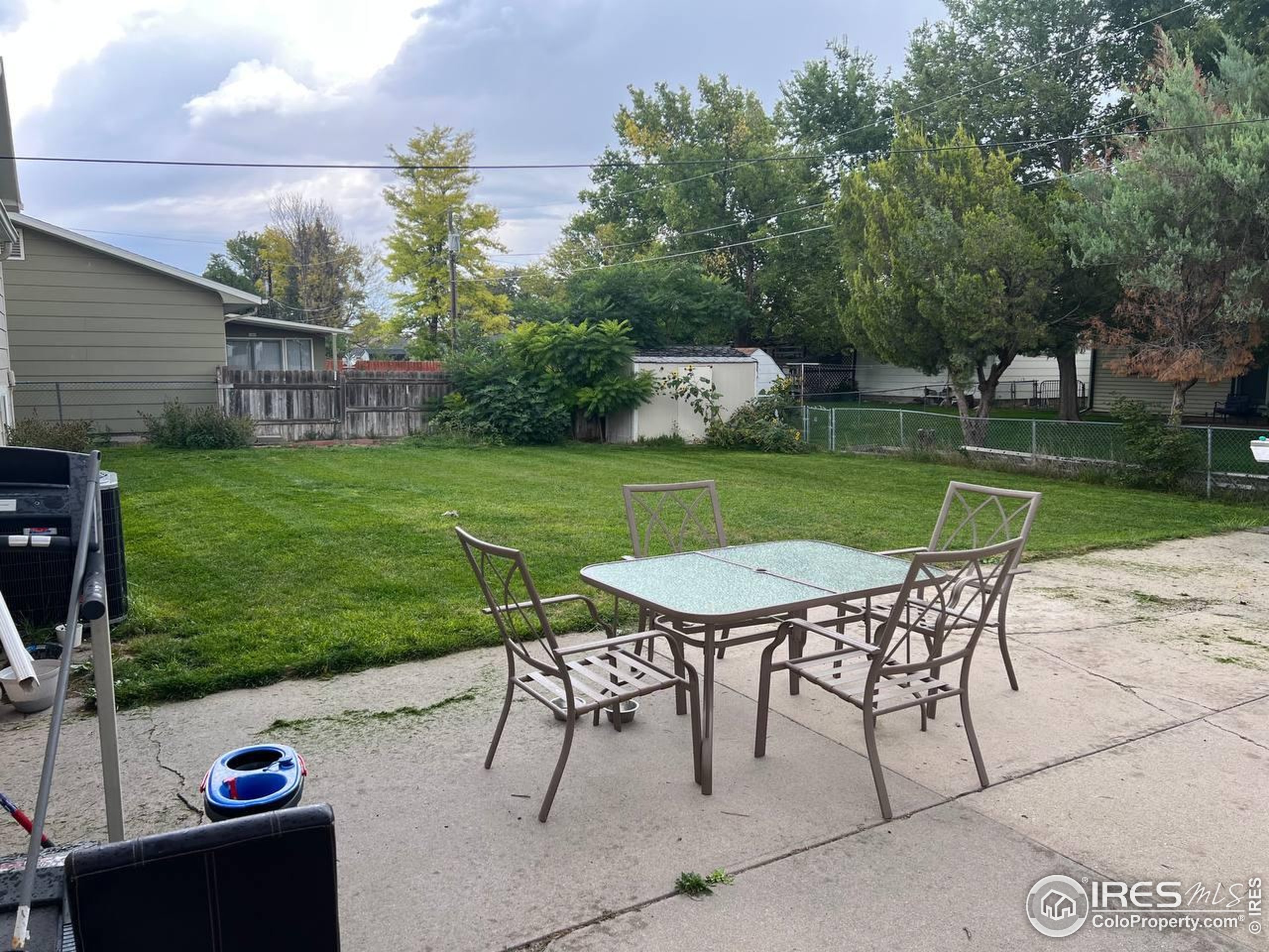 1324 Dawes Street Sterling, CO 80751 - Photo 38 of 39 a view of a wooden dinning table and chairs in the garden