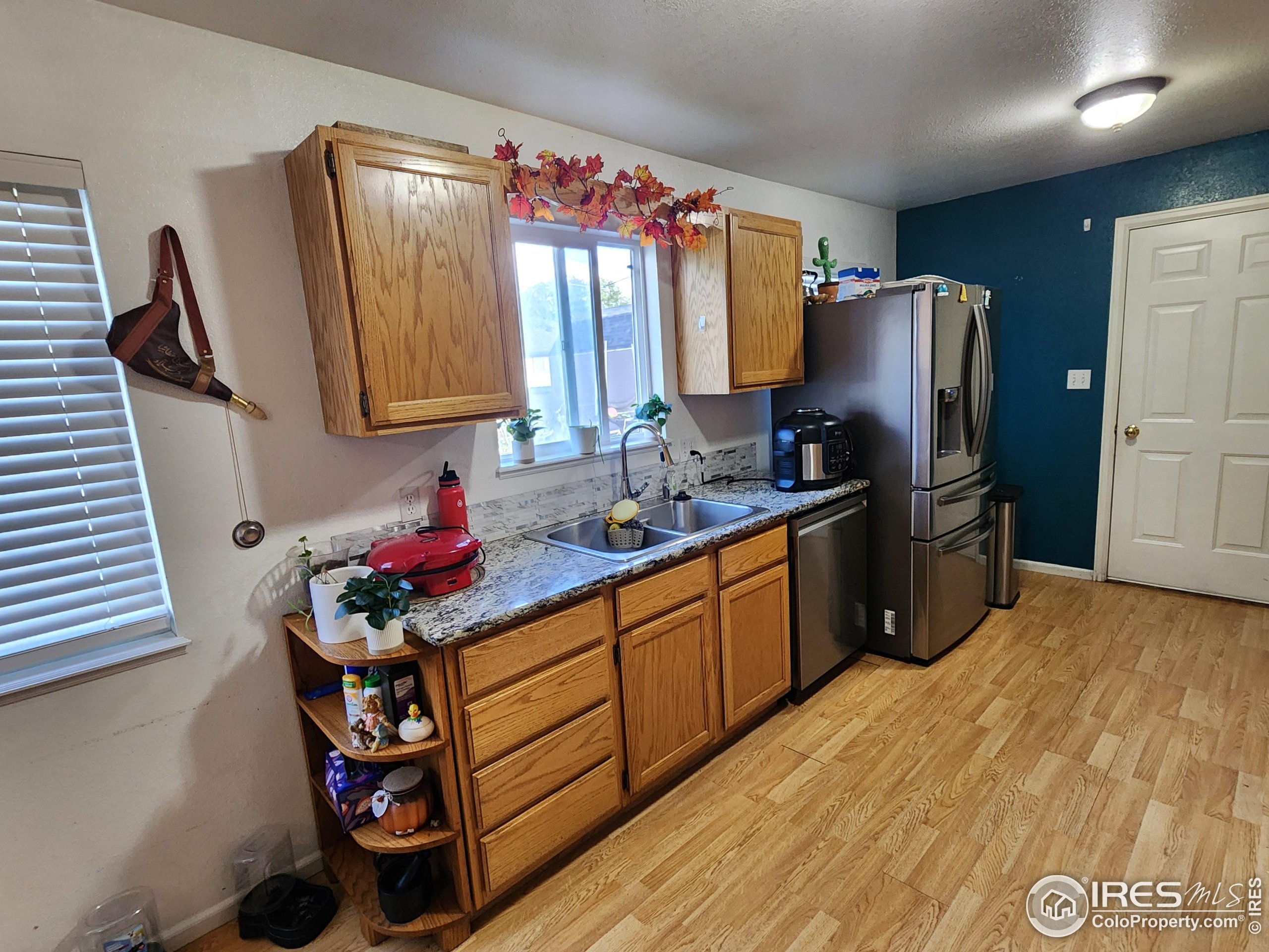 1324 Dawes Street Sterling, CO 80751 - Photo 5 of 39 a kitchen with stainless steel appliances granite countertop a sink stove and refrigerator