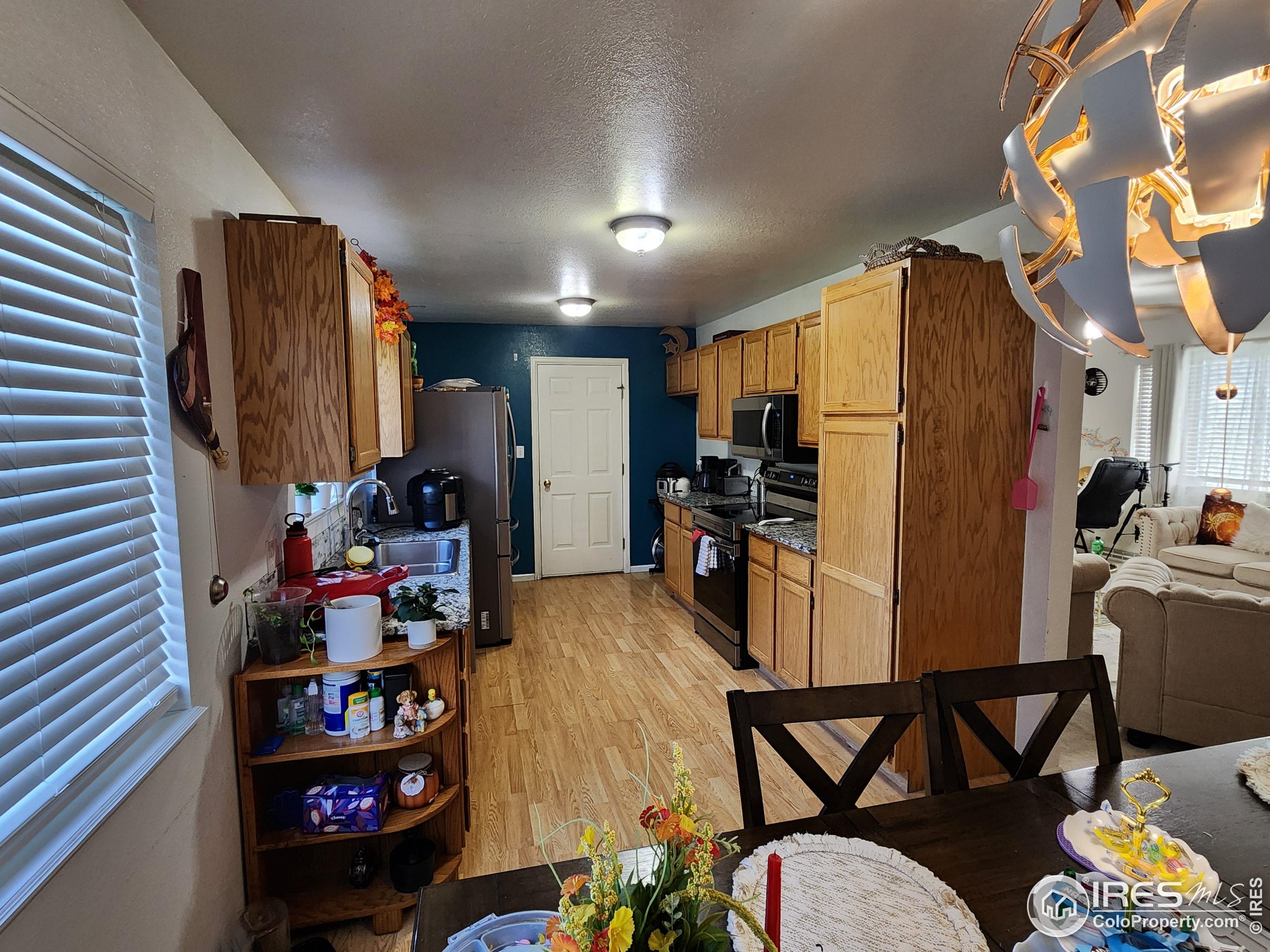 1324 Dawes Street Sterling, CO 80751 - Photo 8 of 39 a view of a kitchen with fridge and workspace