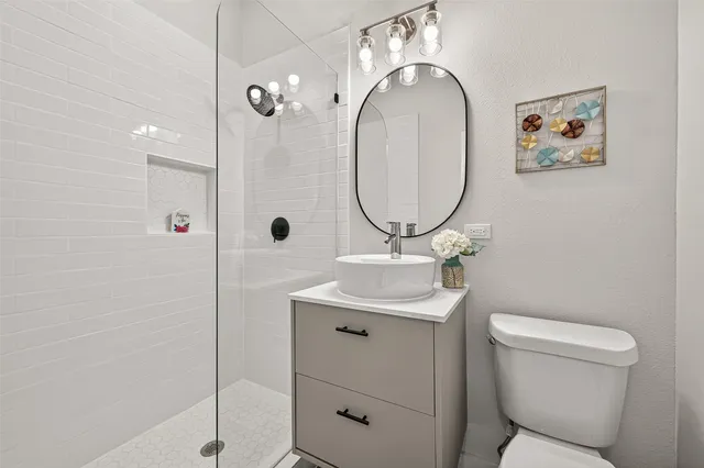 a bathroom with a toilet a sink and mirror