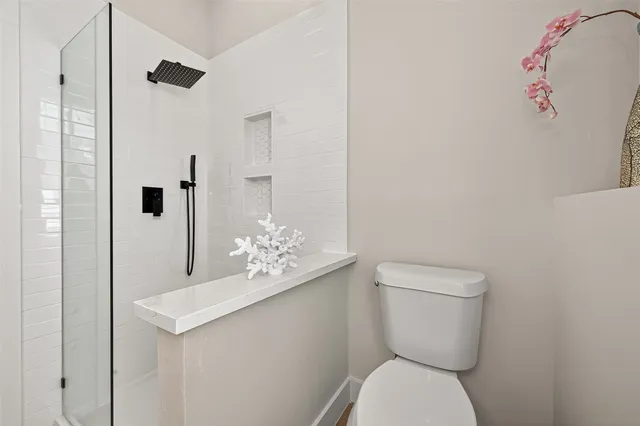 a white toilet sitting next to a bathroom sink