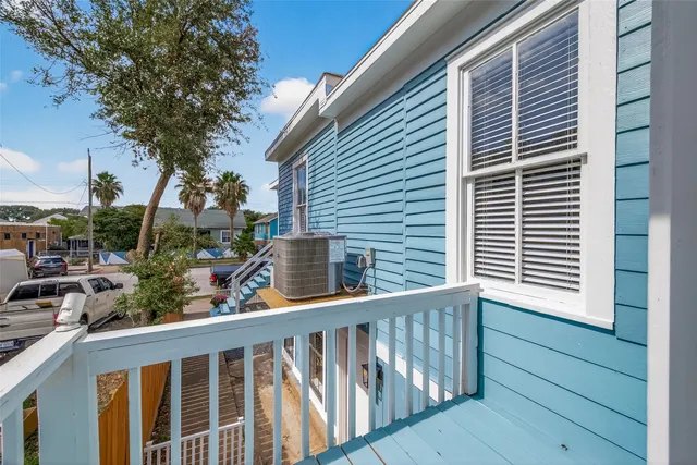 a view of a balcony with wooden floor and fence