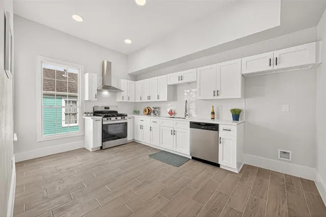 a kitchen with white cabinets and white appliances