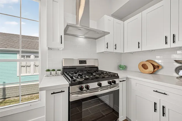 a kitchen with stainless steel appliances cabinets and a window