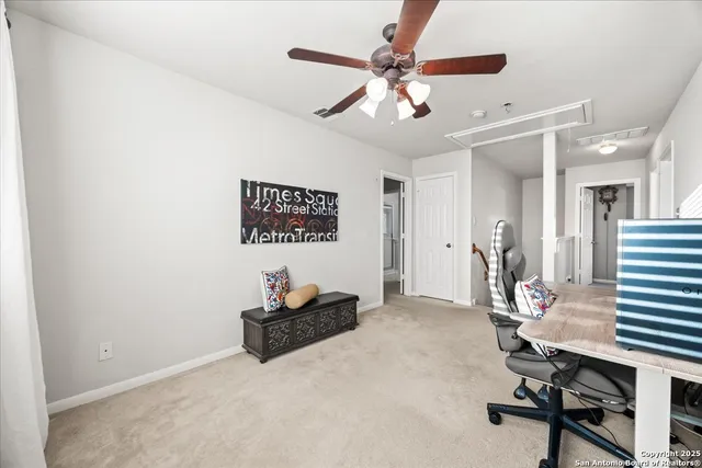 a view of a livingroom with workspace and a window