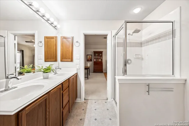 a bathroom with a double vanity sink and a mirror