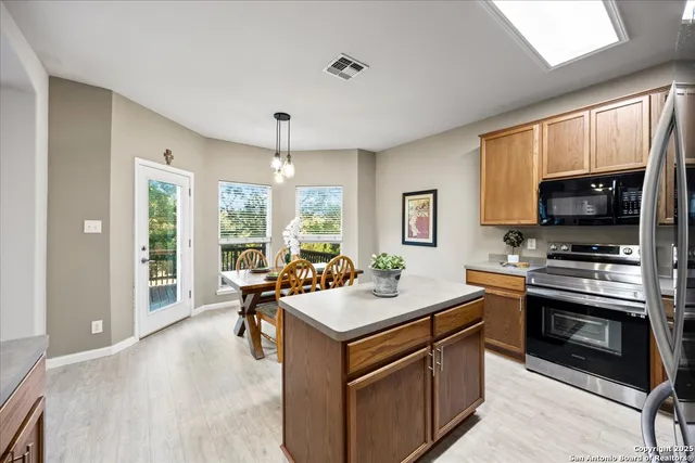 a kitchen with a stove sink and microwave
