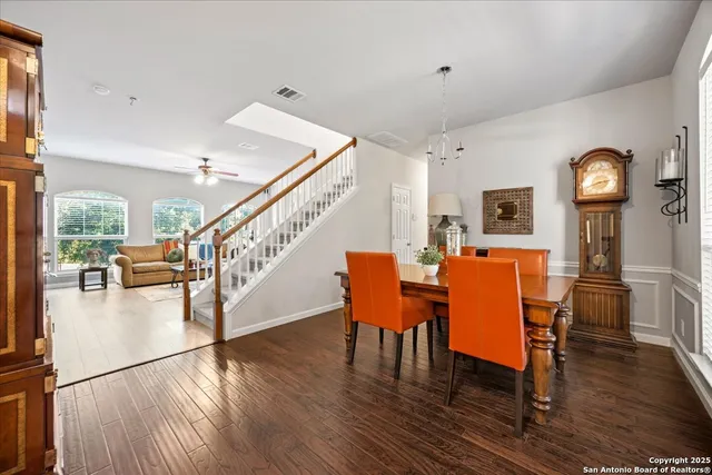 a dining room with furniture entryway and wooden floor