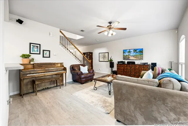 a living room with furniture and a piano