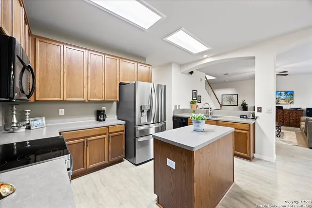 a kitchen with white cabinets and appliances