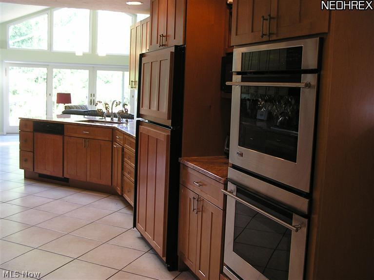2859 Brainard Road Cleveland, OH 44124 - Photo 17 of 25 Large Stainless Double Ovens, Microwave on shelf, Refrigerator/Freezer and dishwasher with panels to match cabinetry.