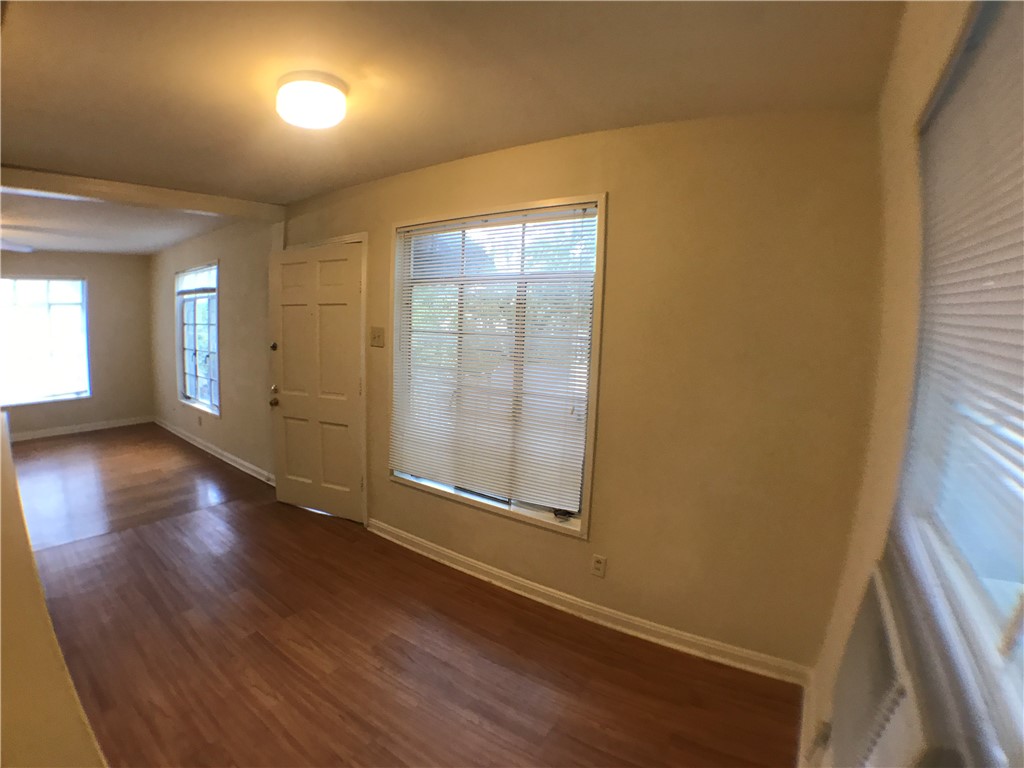 1008 West 25th Street, Unit C Austin, TX 78705 - Photo 5 of 10 wooden floor in an empty room with a window
