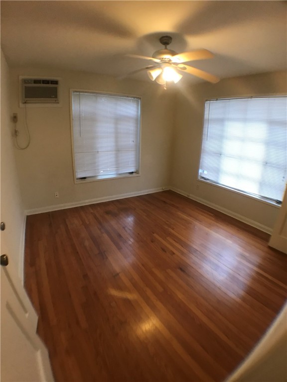 1008 West 25th Street, Unit C Austin, TX 78705 - Photo 7 of 10 an empty room with wooden floor and windows