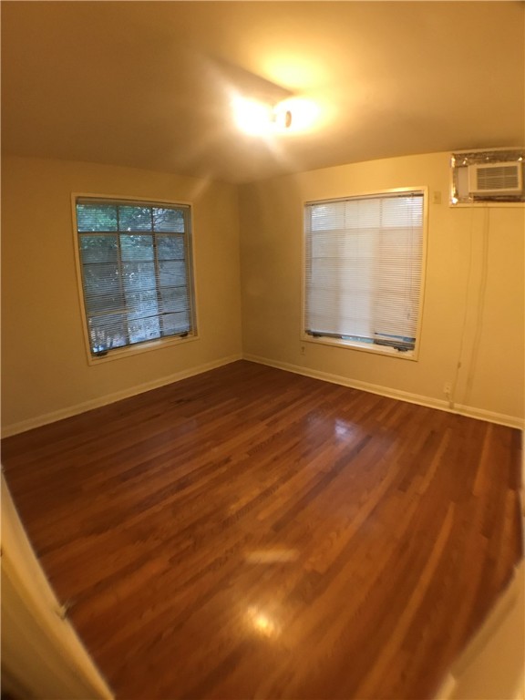 1008 West 25th Street, Unit C Austin, TX 78705 - Photo 9 of 10 an empty room with wooden floor and windows