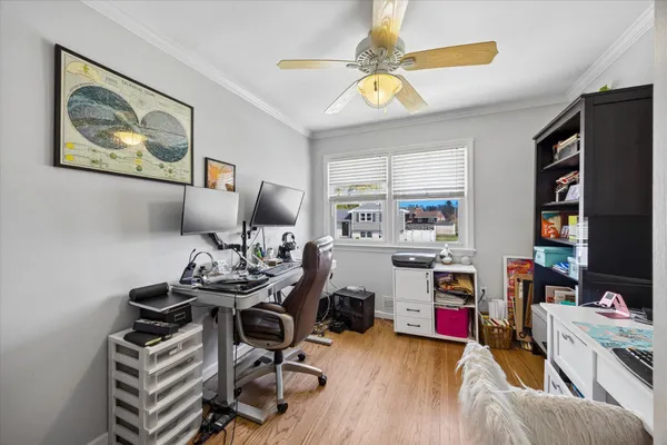 a view of a workspace with furniture and a flat screen tv