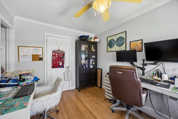 a view of a workspace with furniture and a window