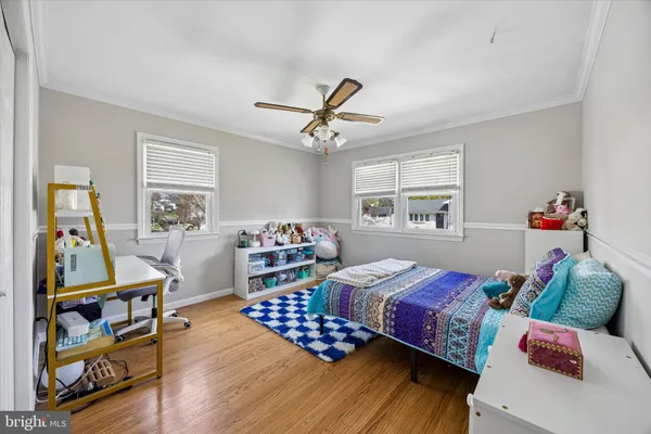 a bedroom with furniture and a wooden floor