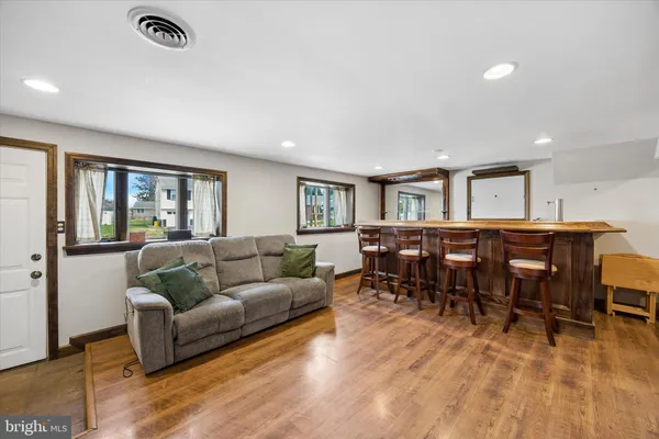 a living room with furniture and a dining table