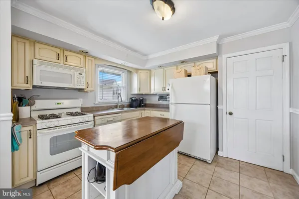 a kitchen with a stove a refrigerator and a sink