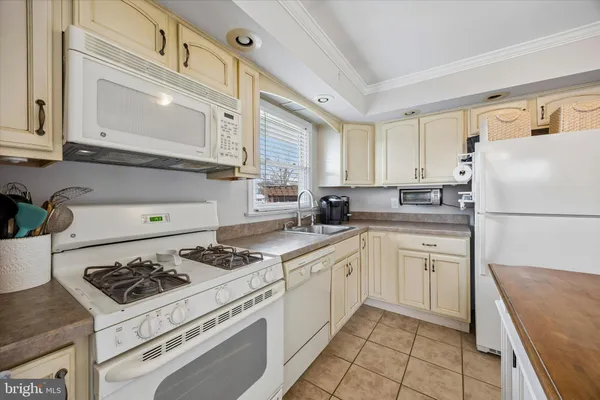 a kitchen with cabinets appliances a sink and a counter top space
