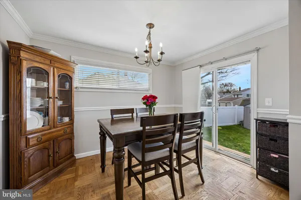 a view of a dining room with furniture wooden floor and chandelier