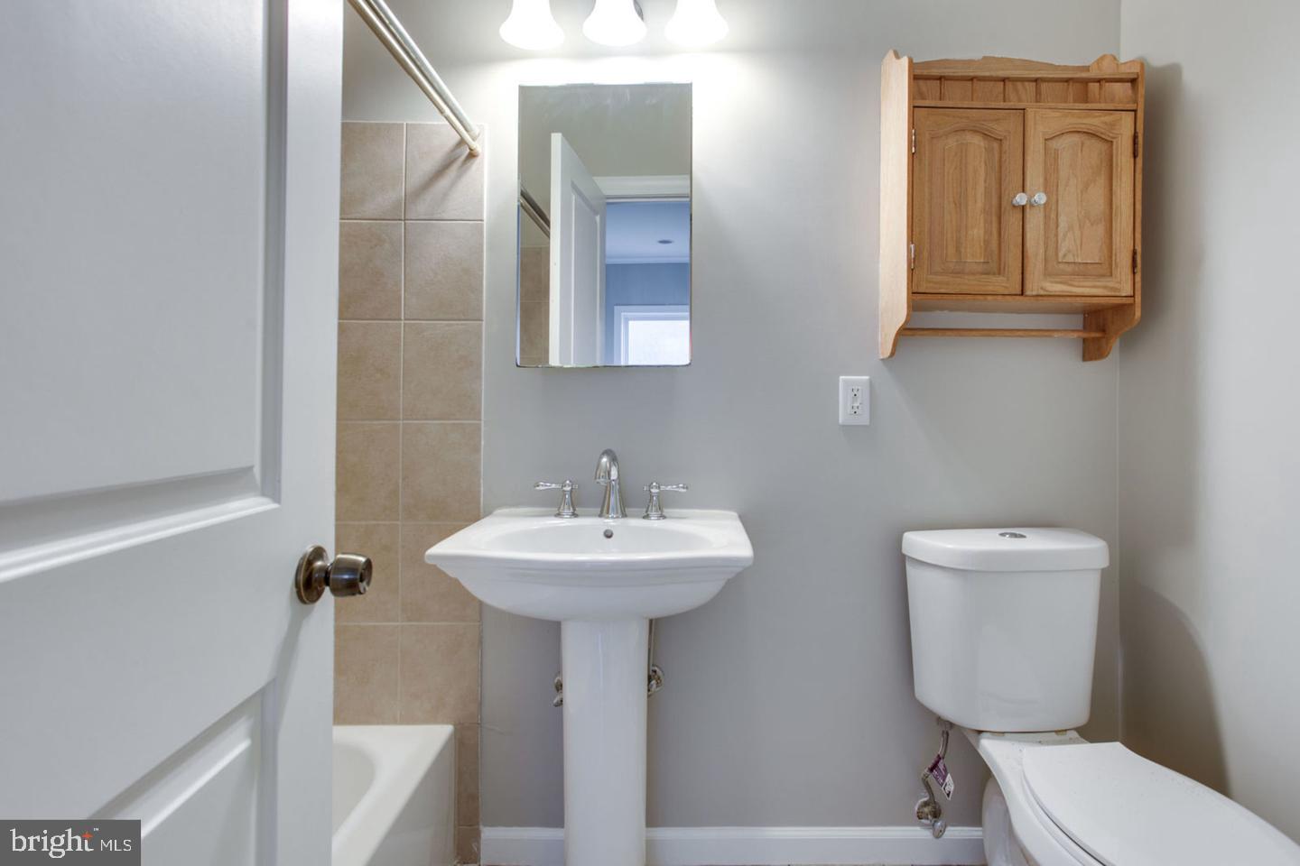 1245 18th Street Northeast, Unit 2 Washington, DC 20002 - Photo 11 of 12 a bathroom with a toilet sink and mirror