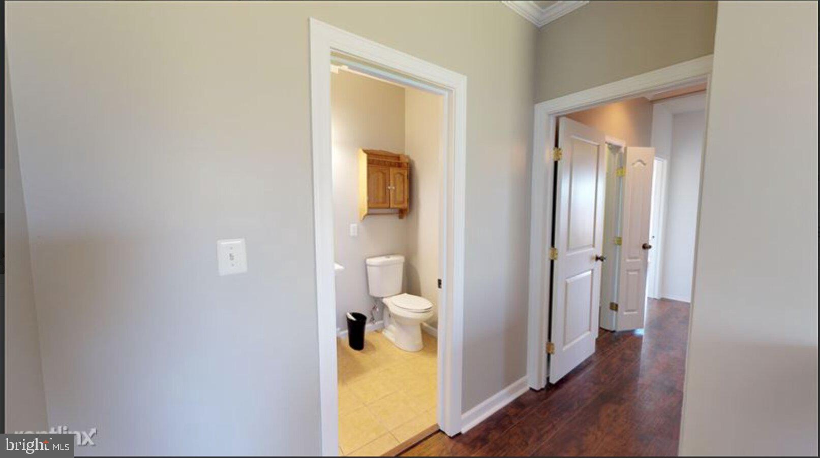 1245 18th Street Northeast, Unit 2 Washington, DC 20002 - Photo 12 of 12 a view of a bathroom with a toilet and a mirror
