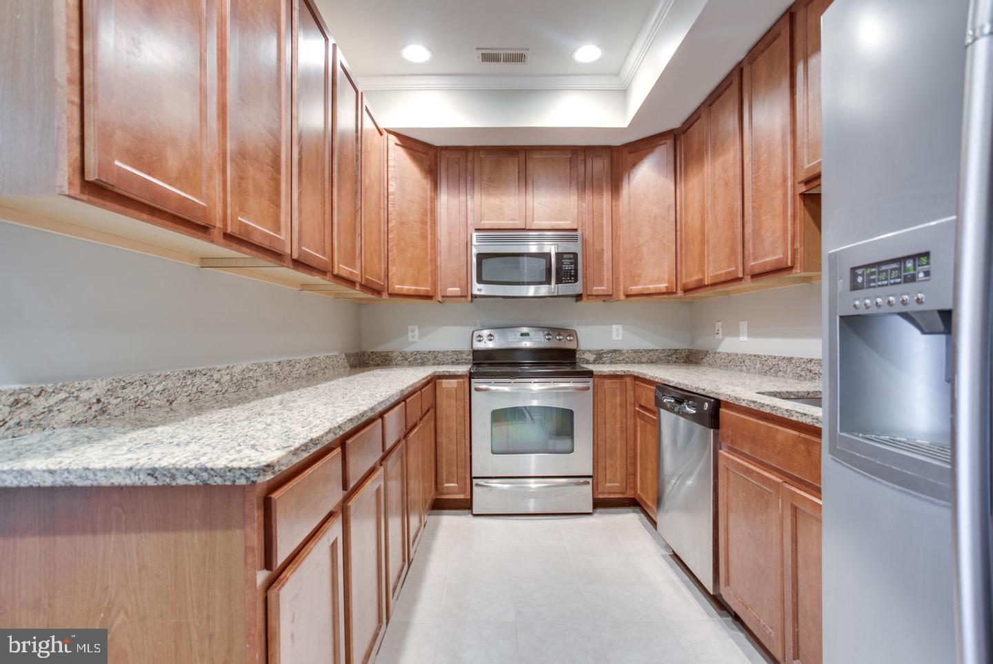 1245 18th Street Northeast, Unit 2 Washington, DC 20002 - Photo 2 of 12 a kitchen with stainless steel appliances granite countertop a refrigerator a stove top oven a sink and dishwasher