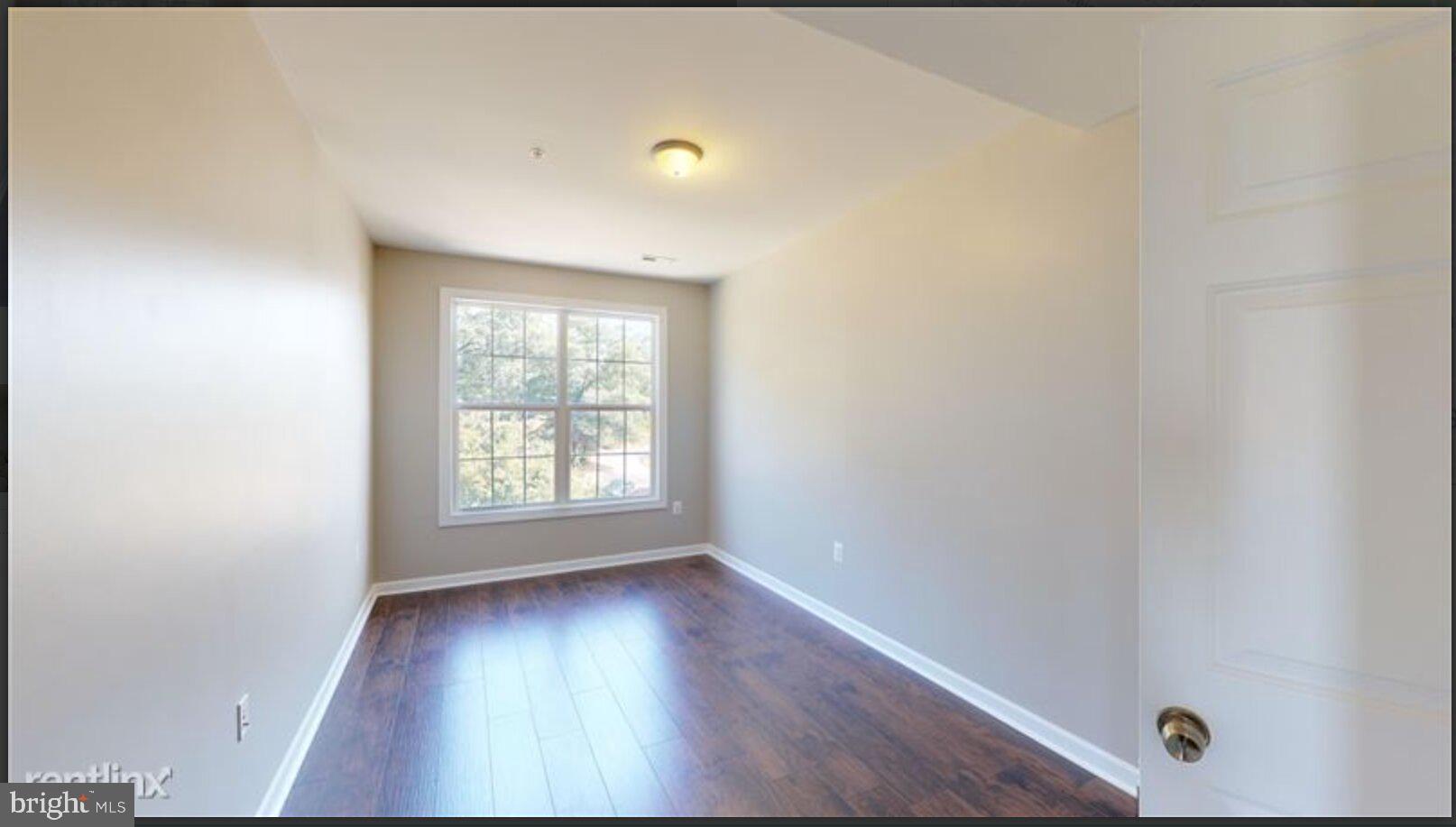 1245 18th Street Northeast, Unit 2 Washington, DC 20002 - Photo 8 of 12 a view of an empty room with wooden floor and a window
