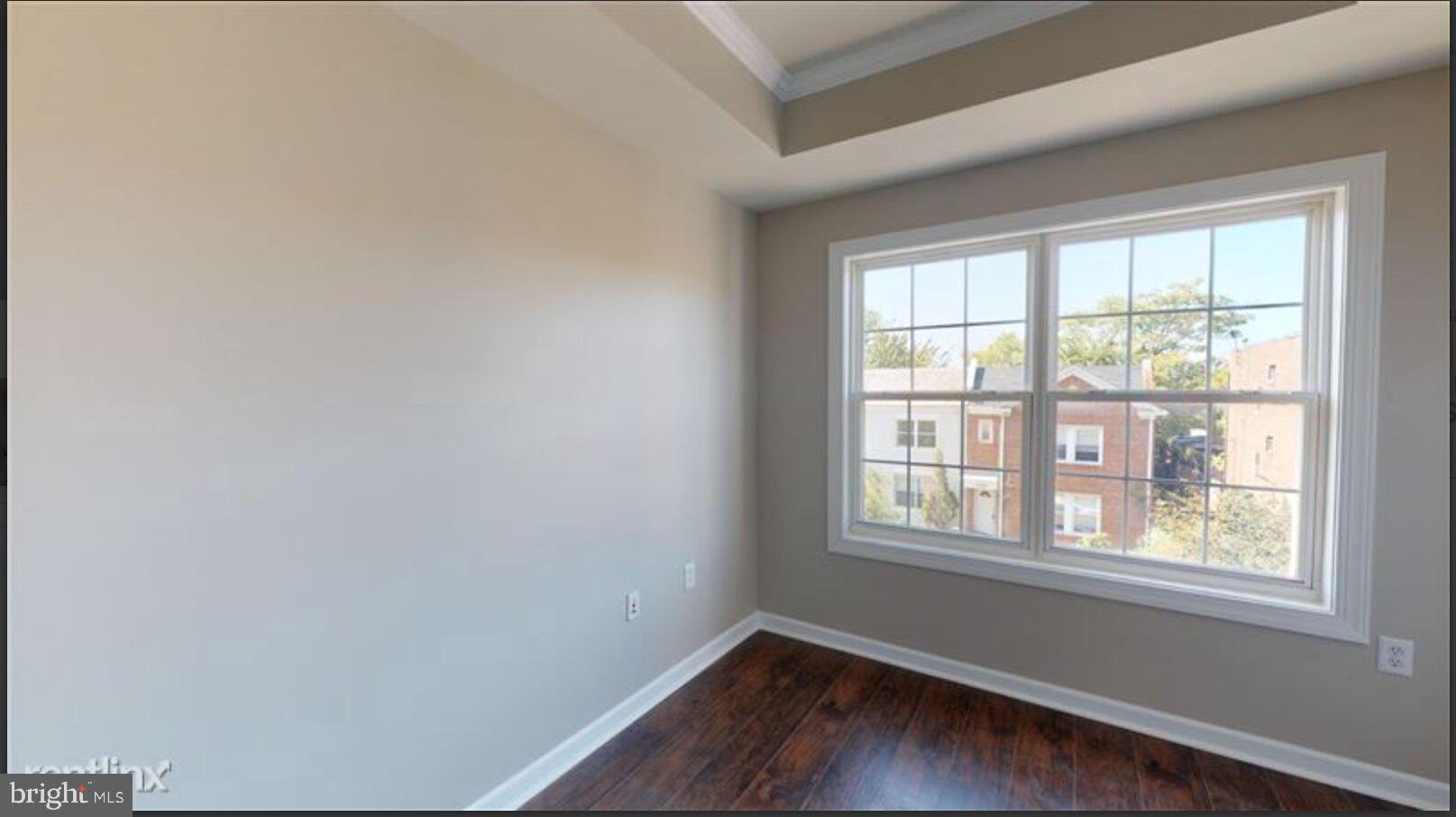 1245 18th Street Northeast, Unit 2 Washington, DC 20002 - Photo 9 of 12 an empty room with wooden floor and windows