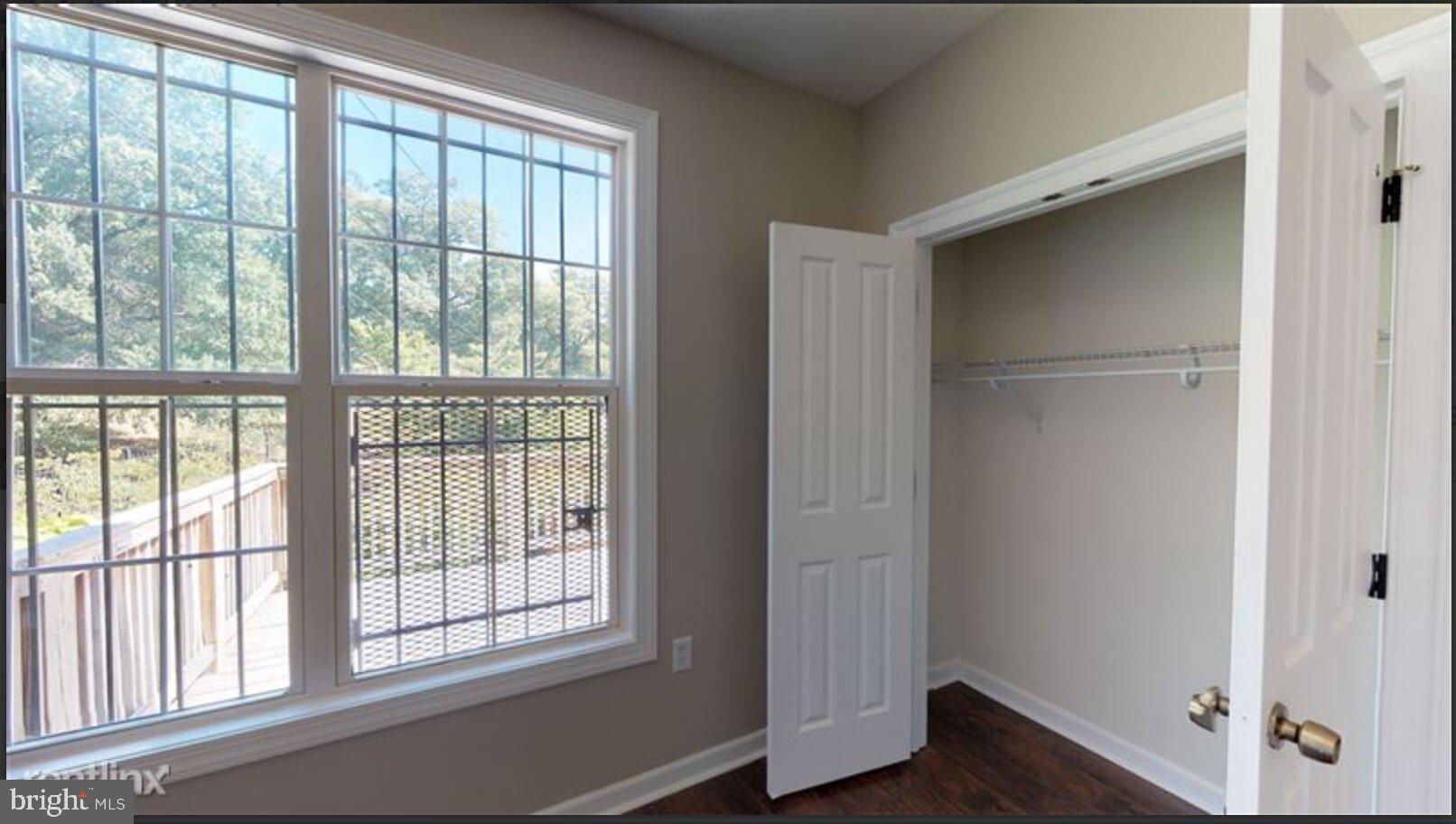 1245 18th Street Northeast, Unit 2 Washington, DC 20002 - Photo 10 of 12 a view of empty room with wooden floor and fan