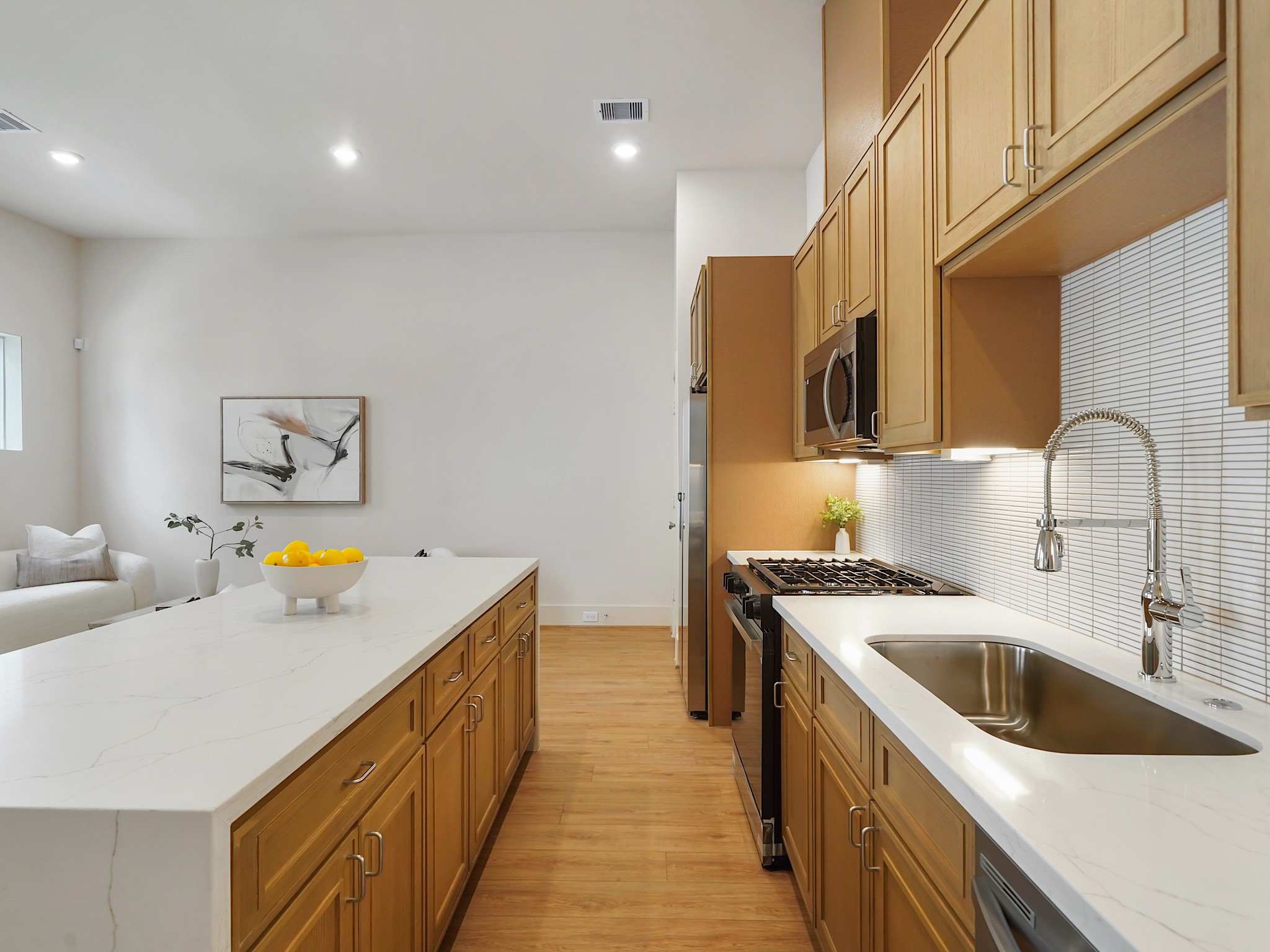 861 Rachel Street, Unit E Houston, TX 77091 - Photo 8 of 29 This sleek kitchen features stainless steel appliances and a stylish breakfast bar, making it perfect for entertaining.