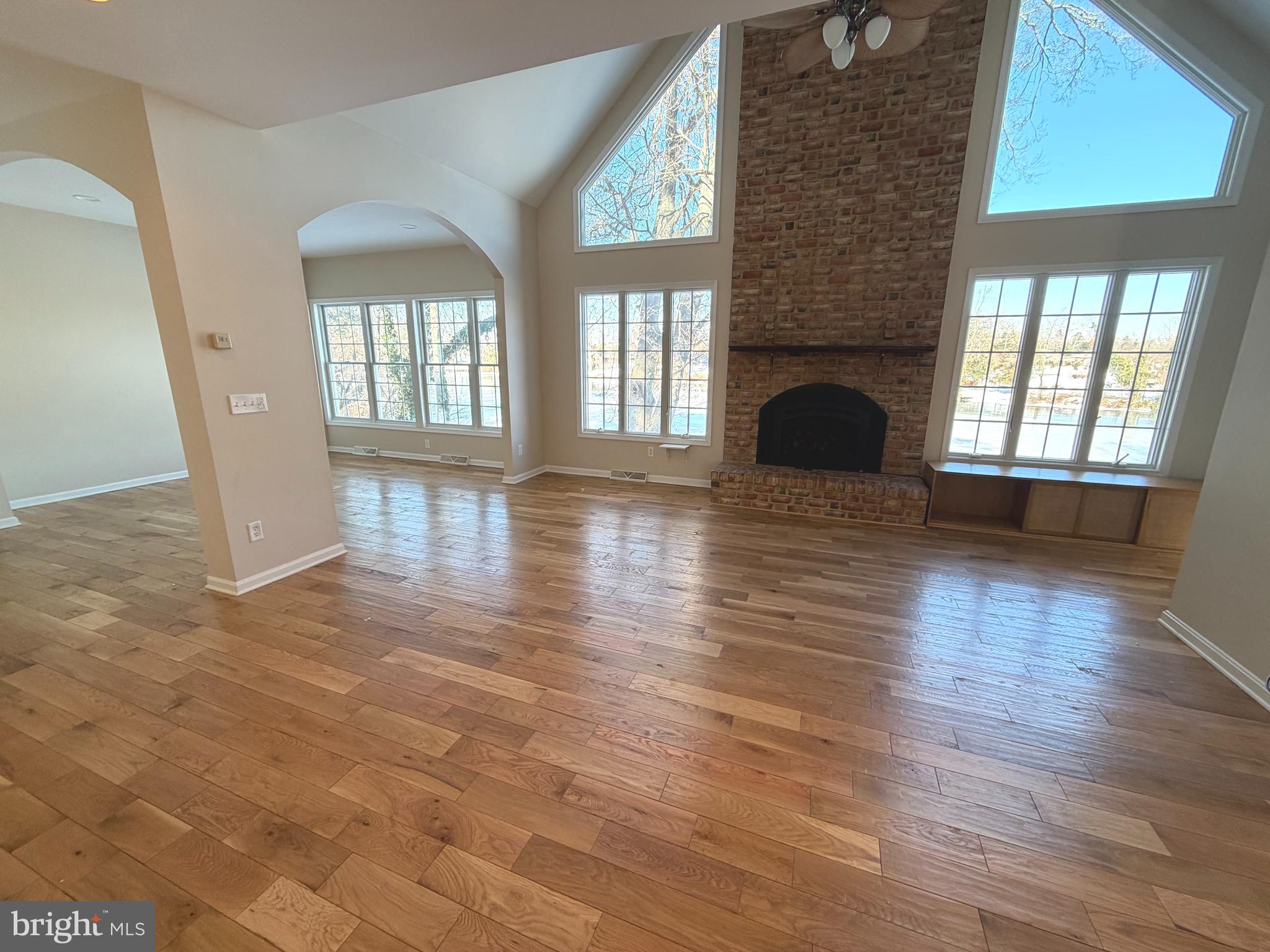 89 South Shore Drive Dover, DE 19901 - Photo 14 of 59 an empty room with wooden floor and fireplace