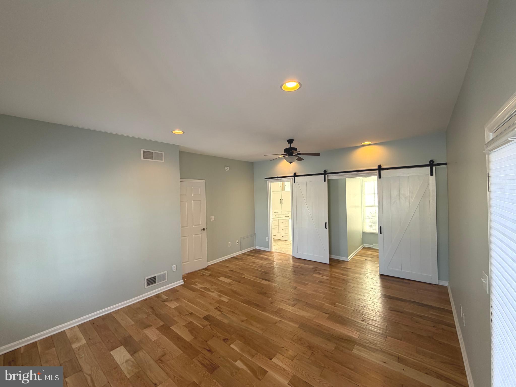 89 South Shore Drive Dover, DE 19901 - Photo 21 of 59 a view of an empty room with wooden floor and a window
