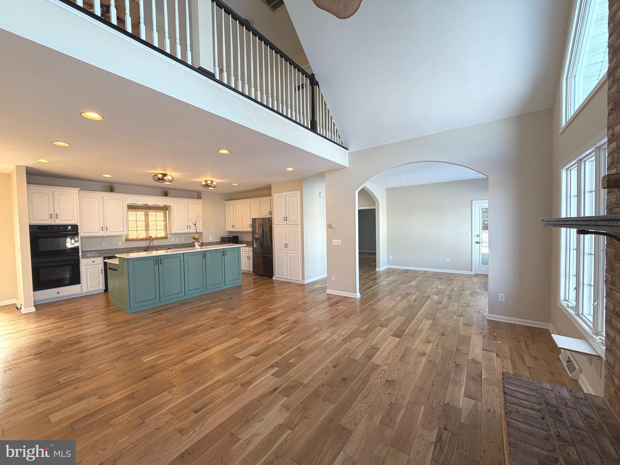 89 South Shore Drive Dover, DE 19901 - Photo 9 of 59 a view of a kitchen with kitchen island wooden floor center island and stainless steel appliances