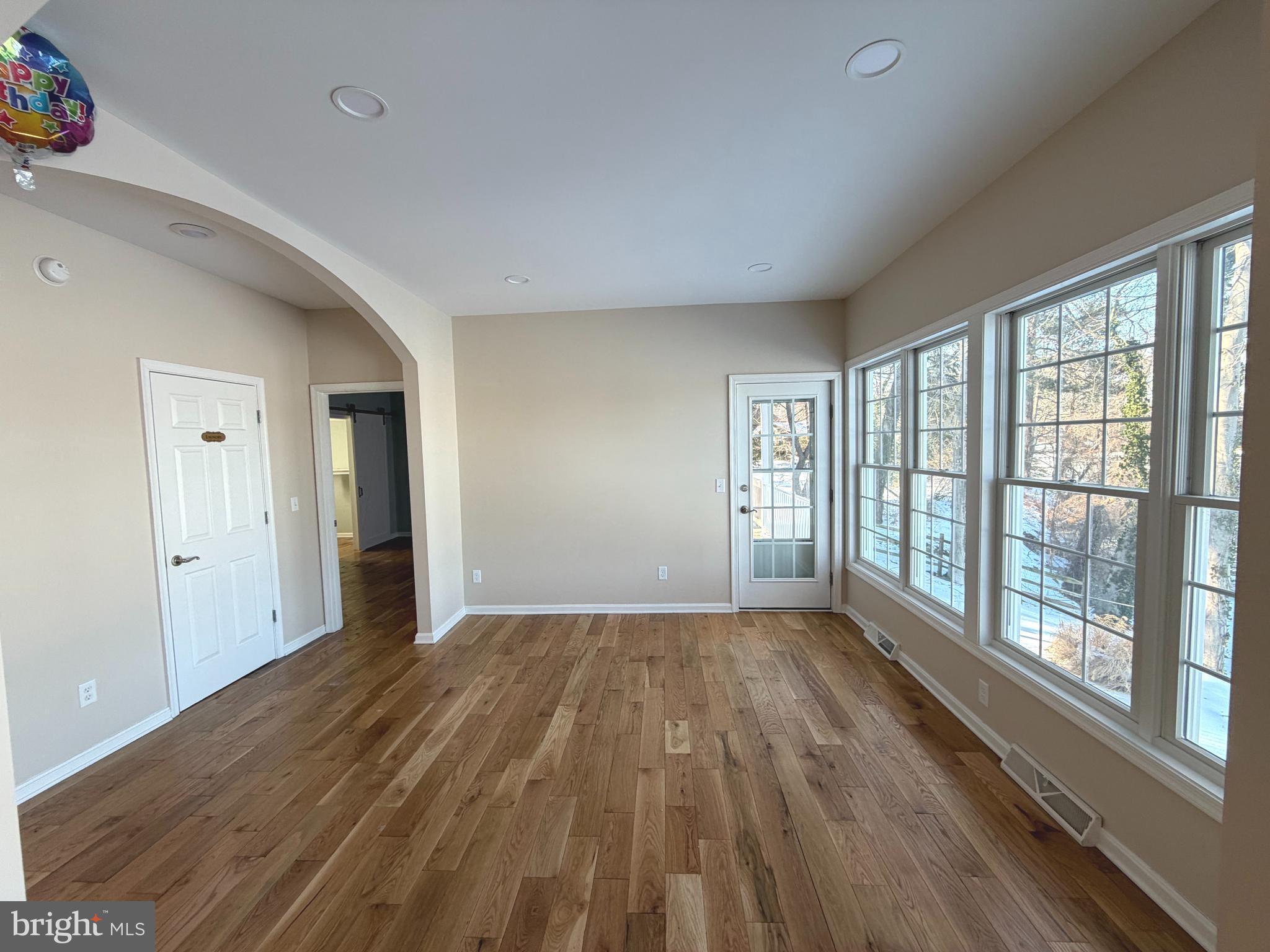 89 South Shore Drive Dover, DE 19901 - Photo 10 of 59 a view of a big room with wooden floor and windows