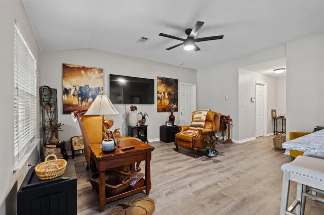 a kitchen with refrigerator and chairs