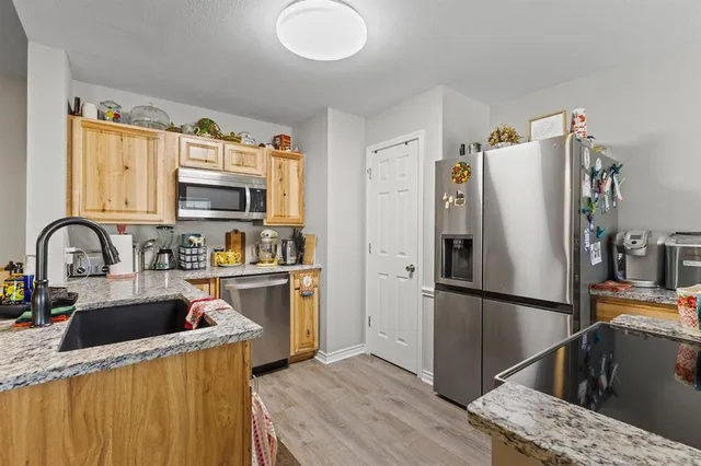 a kitchen with stainless steel appliances granite countertop a stove and a refrigerator