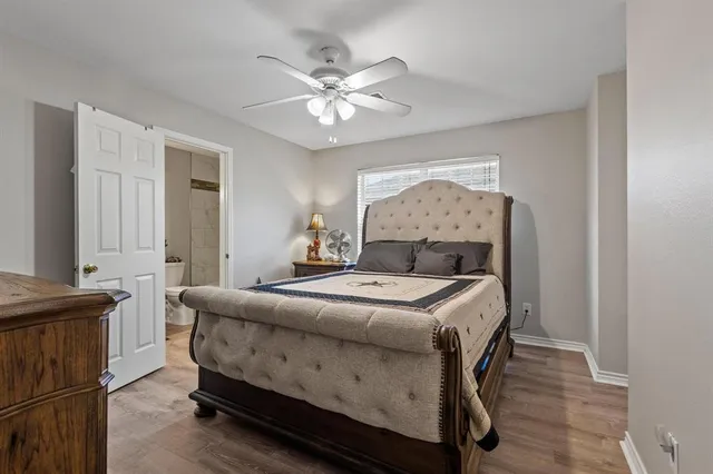 a living room with a bed furniture and a chandelier