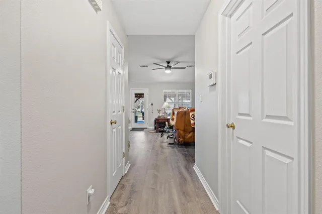 a living room with furniture and a flat screen tv with potted plants