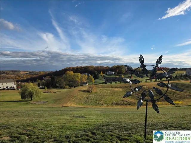 a kitchen with granite countertop a table chairs refrigerator and microwave