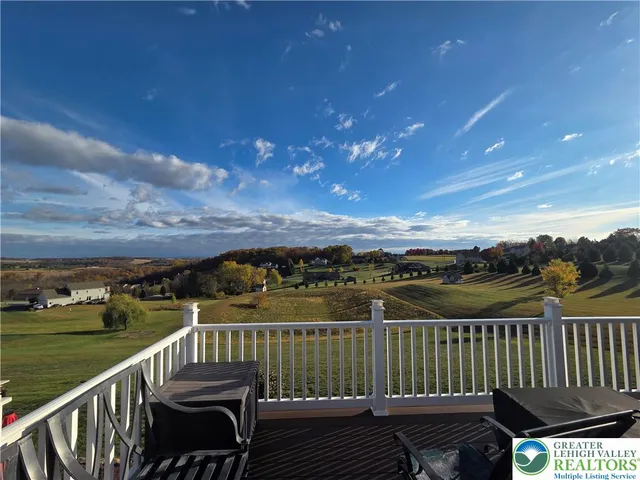 a living room with furniture kitchen view and a window