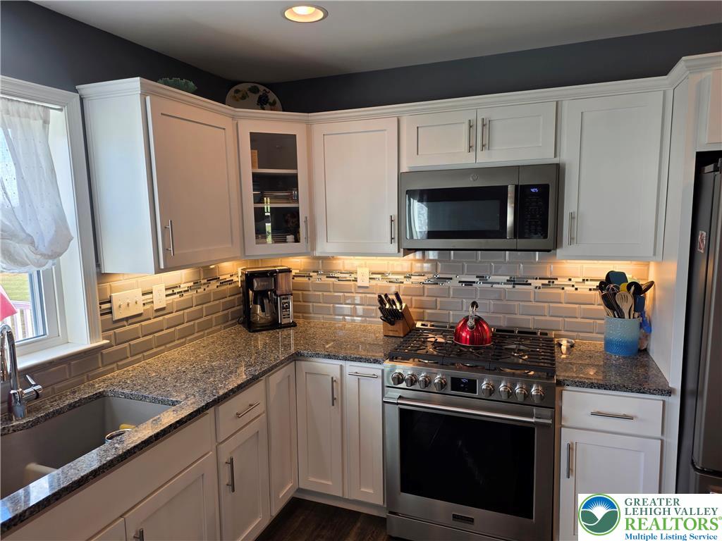 3393 Crestview Lane Walnutport, PA 18088 - Photo 20 of 68 a kitchen with stainless steel appliances granite countertop a stove microwave and sink